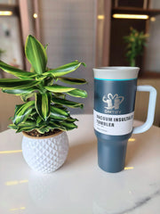 Navy blue Vacuum insulated tumbler with a plant on a table