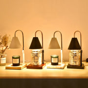 Four table lamps with candles on a wooden surface, softly lit.