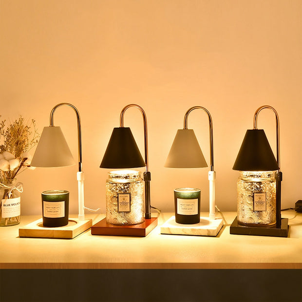 Four table lamps with candles on a wooden surface, softly lit.