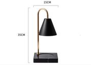 Black table lamp with gold accents and measurements on a white background