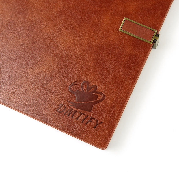 Brown leather-bound notebook with gold clasp on a white background