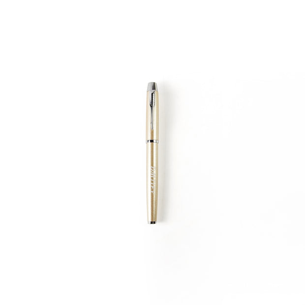 Gold pen on a white background