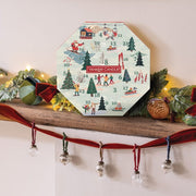 Yankee Candle advent calendar on a decorative shelf with Christmas decorations.