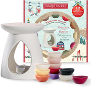 White wax warmer with colorful wax melts and Yankee Candle packaging in the background.