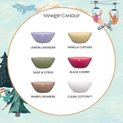Yankee Candle scented candles with colorful bowls and labels on a decorative background.