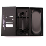 Black candle accessories set in an open box on a white background