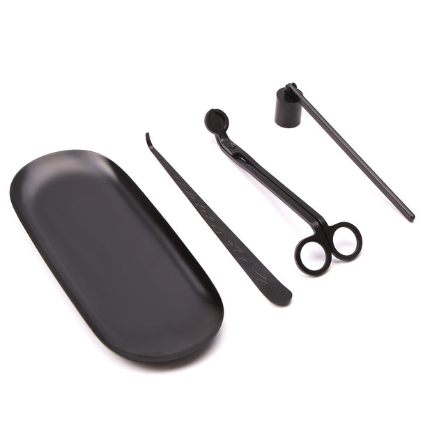 Set of black candle care tools on a white background